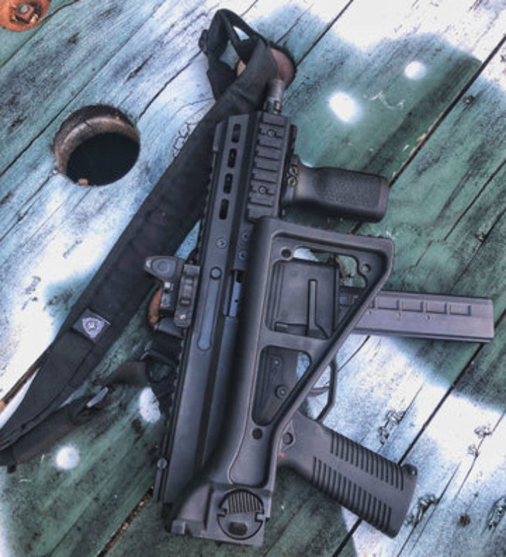 Photo showing the Ferro Concepts Single Point Slingster in real use demonstrating secure weapon retention and smooth shoulder transitions for a sub-gun or PDW. The padded single point sling with welded steel ring, rubberized quick-adjust pull tab, and metal quick release buckle ensures fast, reliable weapon handling during tactical operations, CQB, and law enforcement missions